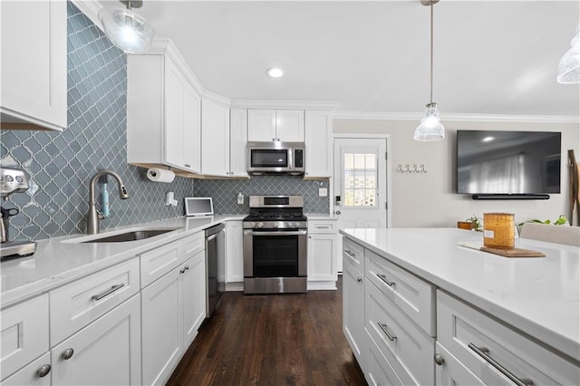 kitchen with white cabinetry, hanging light fixtures, sink, and appliances with stainless steel finishes