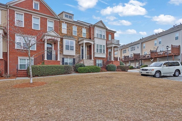 multi unit property featuring brick siding and a residential view