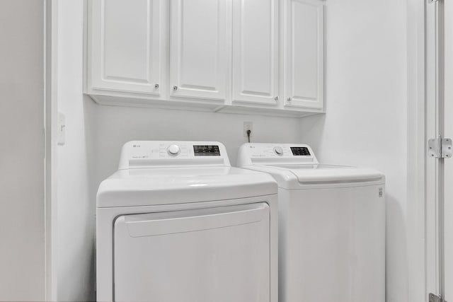 laundry room with cabinet space and washer and clothes dryer