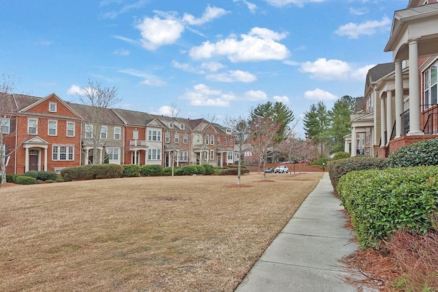 view of community with a lawn and a residential view