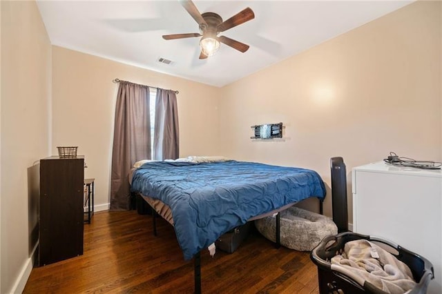 bedroom featuring ceiling fan and dark hardwood / wood-style floors