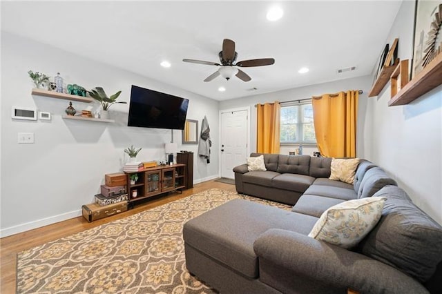 living room featuring ceiling fan and hardwood / wood-style flooring