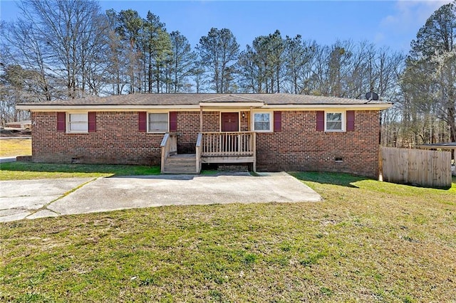 ranch-style house with crawl space, fence, a front lawn, and brick siding