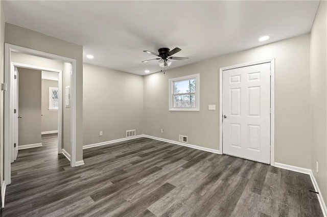 interior space featuring dark wood-style flooring, visible vents, and recessed lighting