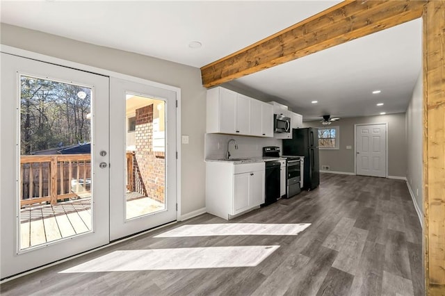 kitchen with dark wood-style flooring, tasteful backsplash, white cabinets, beamed ceiling, and black appliances