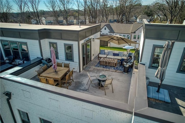 back of property with outdoor lounge area and a patio area