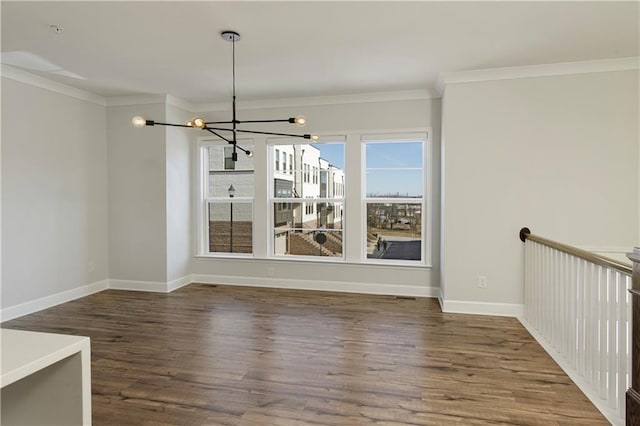 unfurnished dining area with baseboards, an inviting chandelier, ornamental molding, and wood finished floors