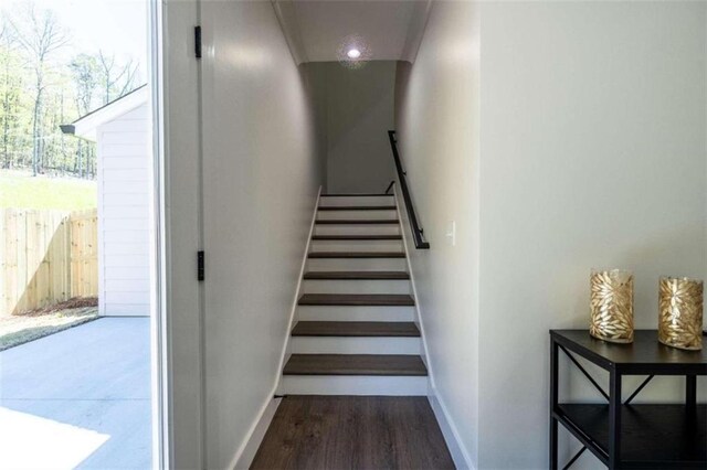 stairs featuring hardwood / wood-style floors