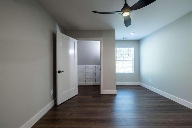 unfurnished bedroom featuring ceiling fan and dark wood-type flooring