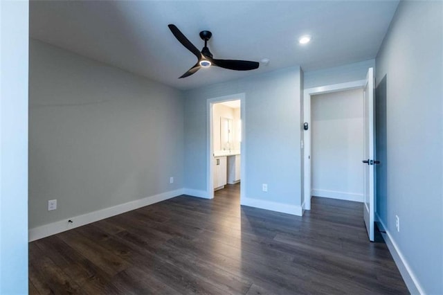 unfurnished bedroom featuring dark hardwood / wood-style floors, ceiling fan, and ensuite bathroom