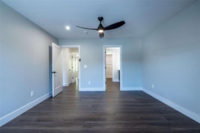 unfurnished bedroom featuring dark hardwood / wood-style floors and ceiling fan