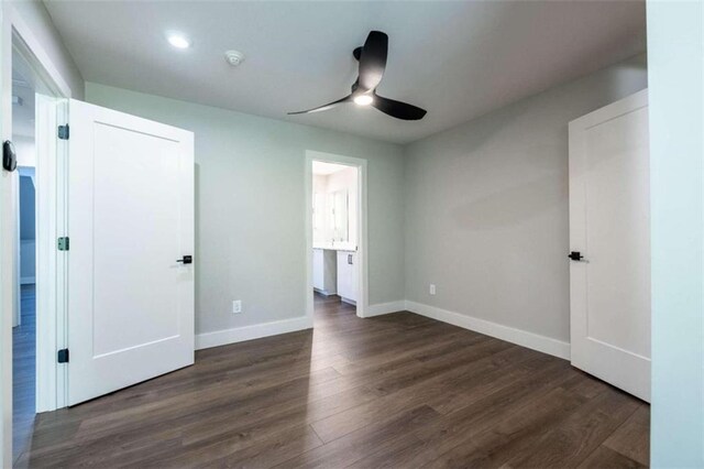 unfurnished bedroom featuring dark hardwood / wood-style flooring and ceiling fan