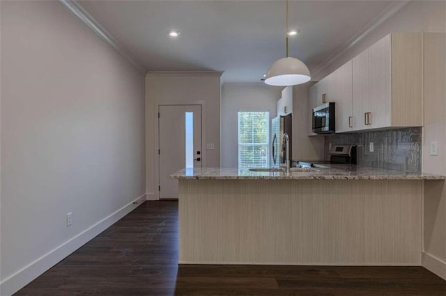 kitchen featuring dark hardwood / wood-style floors, light stone countertops, stainless steel appliances, and decorative light fixtures