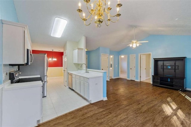 kitchen featuring sink, white cabinets, and ceiling fan with notable chandelier