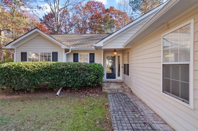 entrance to property featuring a yard