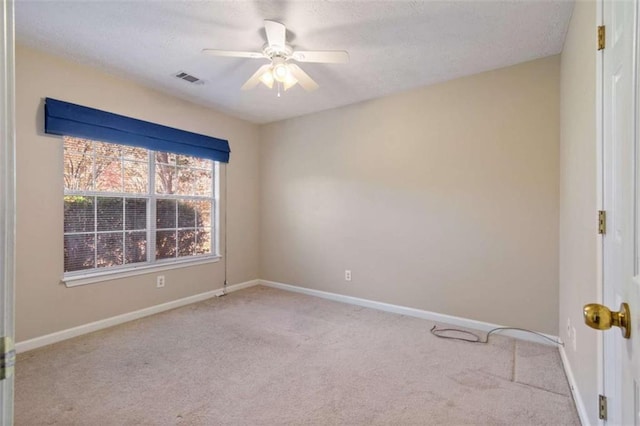 spare room with light carpet and ceiling fan