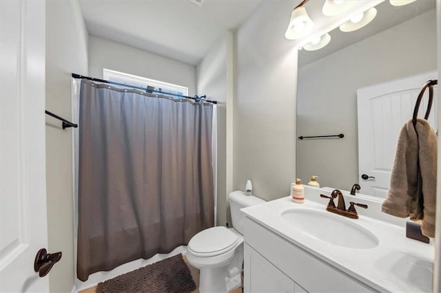 full bathroom with vanity, shower / tub combo, and toilet