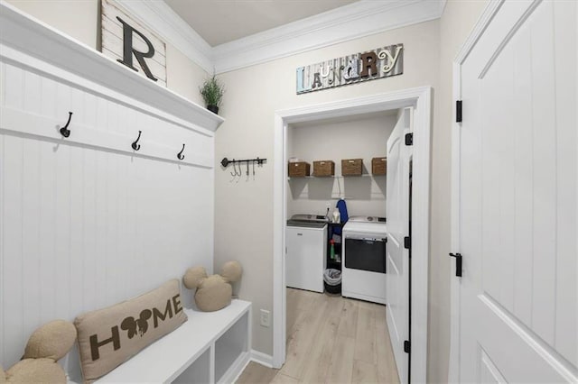 mudroom with crown molding, light wood-type flooring, and washer and clothes dryer