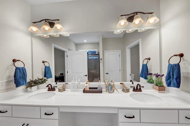 bathroom featuring walk in shower and vanity