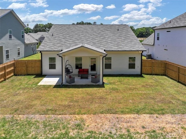 rear view of house featuring central AC, a lawn, and a patio area