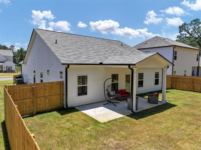 rear view of property with central AC unit, a yard, and a patio