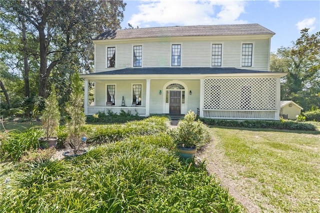 view of front of property with a front yard and covered porch