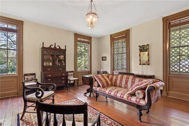 sitting room with an inviting chandelier, hardwood / wood-style flooring, and a wealth of natural light