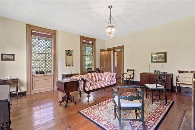 living room featuring a notable chandelier, plenty of natural light, and dark hardwood / wood-style flooring