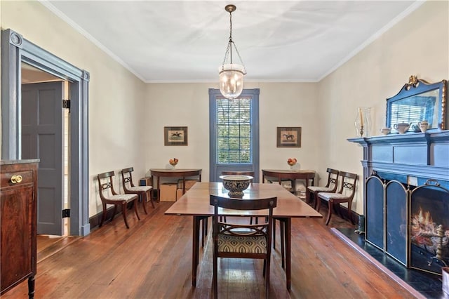 dining room with crown molding and dark wood-type flooring