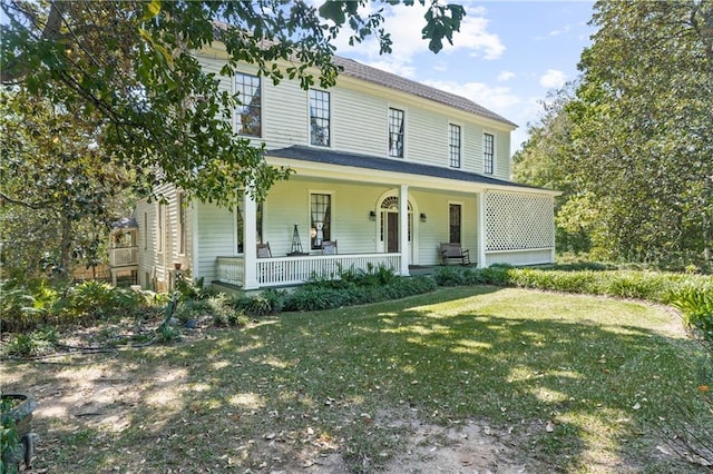 view of front of property featuring a front yard and covered porch