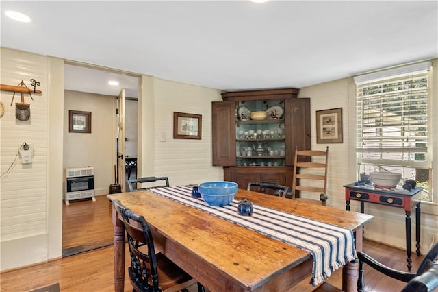 dining room featuring heating unit, plenty of natural light, and light hardwood / wood-style flooring