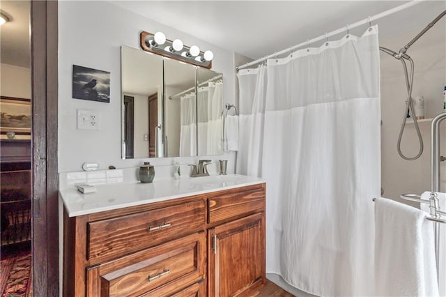 bathroom featuring curtained shower, hardwood / wood-style flooring, and vanity