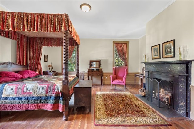 bedroom featuring ornamental molding and hardwood / wood-style flooring