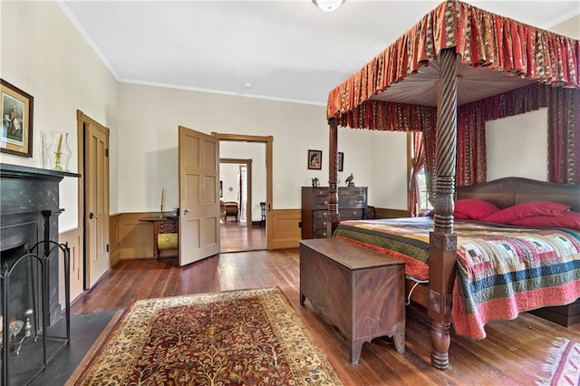 bedroom with crown molding and dark hardwood / wood-style flooring