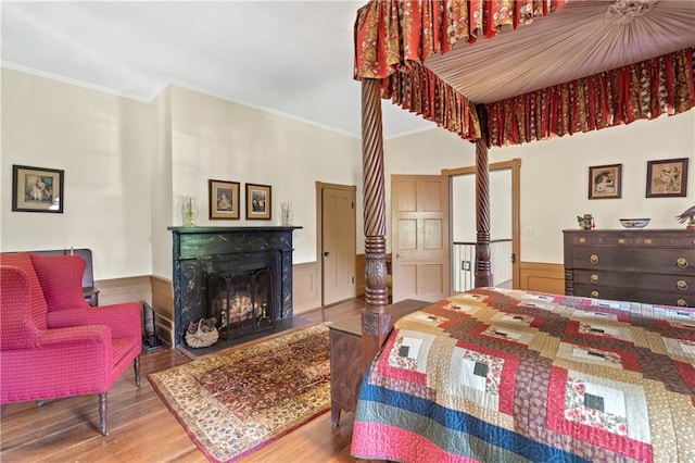 bedroom featuring hardwood / wood-style flooring and crown molding