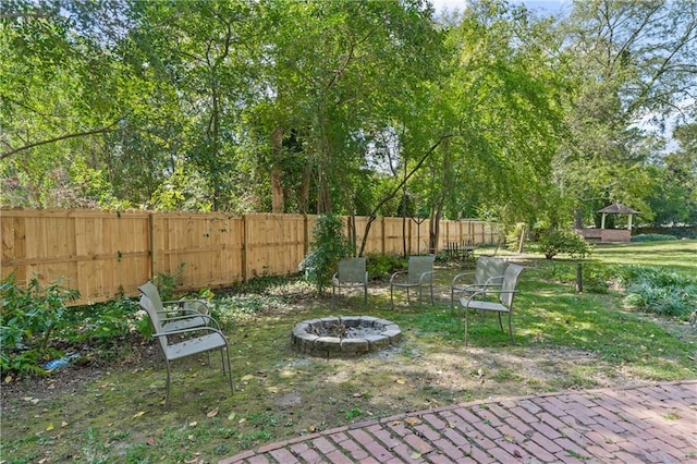 view of yard with a fire pit