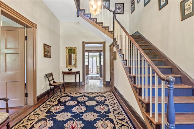 foyer featuring a high ceiling and dark hardwood / wood-style floors