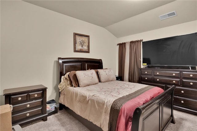 bedroom featuring lofted ceiling and light colored carpet