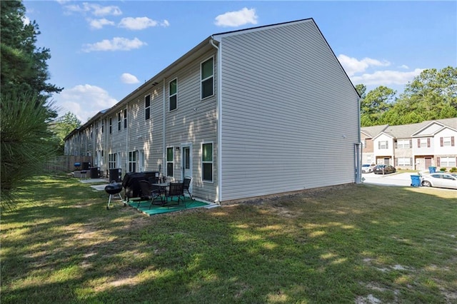 rear view of house featuring a yard and a patio area