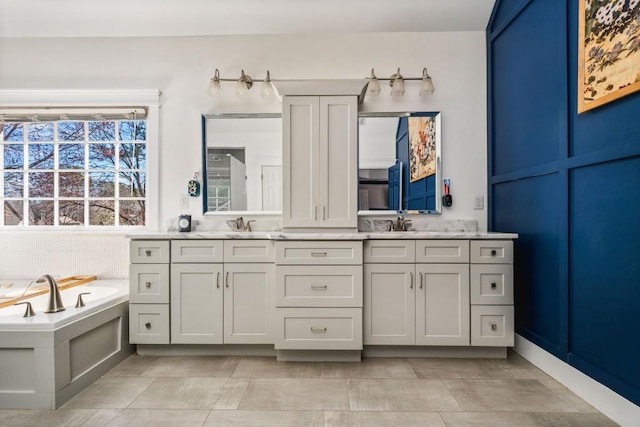 bathroom featuring double vanity, a sink, backsplash, and a bath