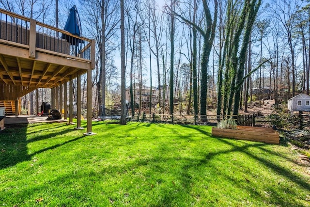 view of yard featuring fence and a deck