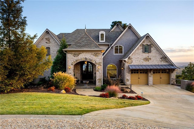 french provincial home with a garage and a lawn