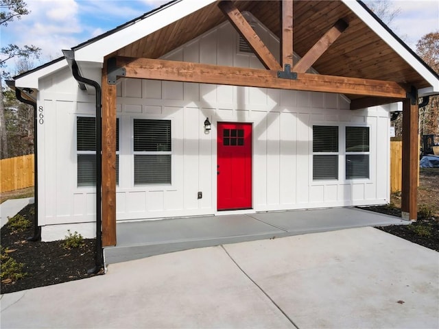 exterior space with fence and board and batten siding