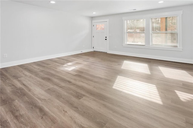 interior space with recessed lighting, baseboards, and wood finished floors