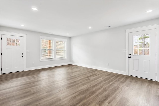 foyer entrance featuring plenty of natural light, visible vents, wood finished floors, and recessed lighting