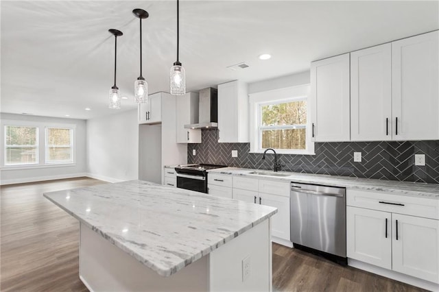 kitchen featuring electric range oven, stainless steel dishwasher, wall chimney range hood, white cabinetry, and a sink