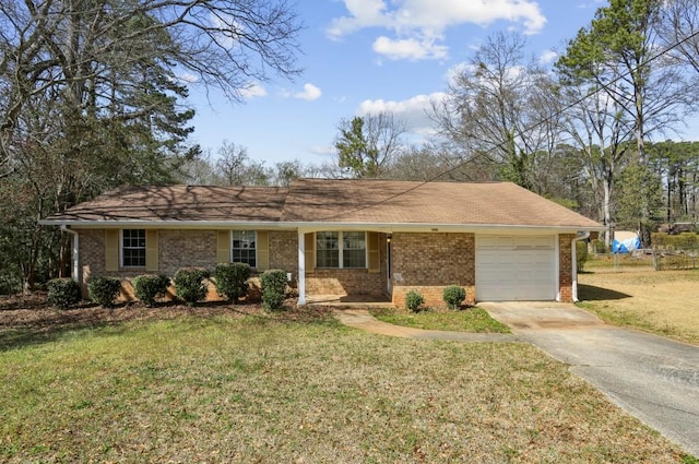 ranch-style home featuring brick siding, a garage, concrete driveway, and a front lawn