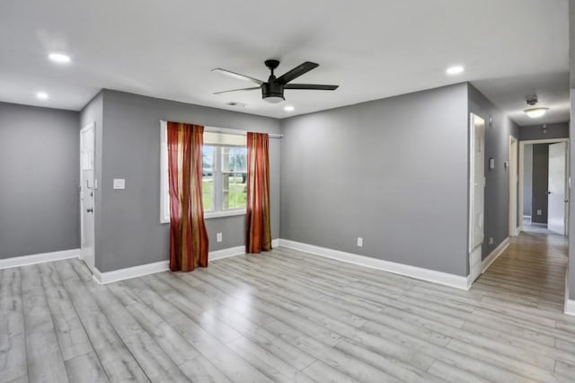 empty room with visible vents, a ceiling fan, recessed lighting, light wood finished floors, and baseboards