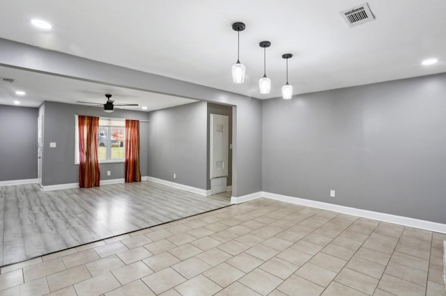 empty room featuring recessed lighting, baseboards, and visible vents