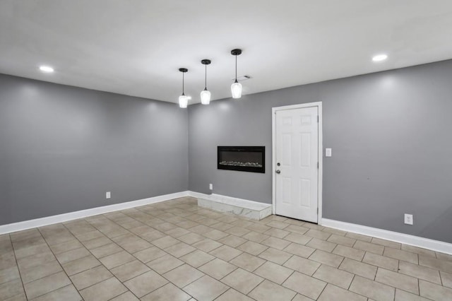 unfurnished room with recessed lighting and baseboards